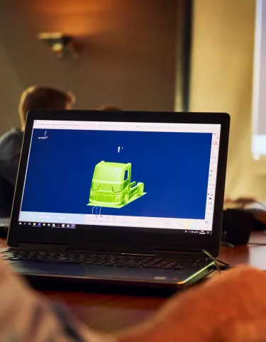 Meeting with the design team, with a 3D truck on a screen