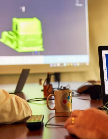 Meeting with the design team, with a 3D truck on a screen